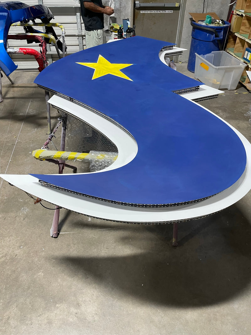 Blue Houston Texans logo piece with a yellow star, freshly painted in the ReveMoto paint shop