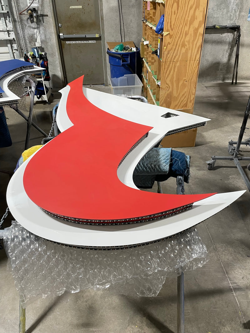 Red and white Houston Texans logo piece freshly painted in the ReveMoto paint shop in Houston